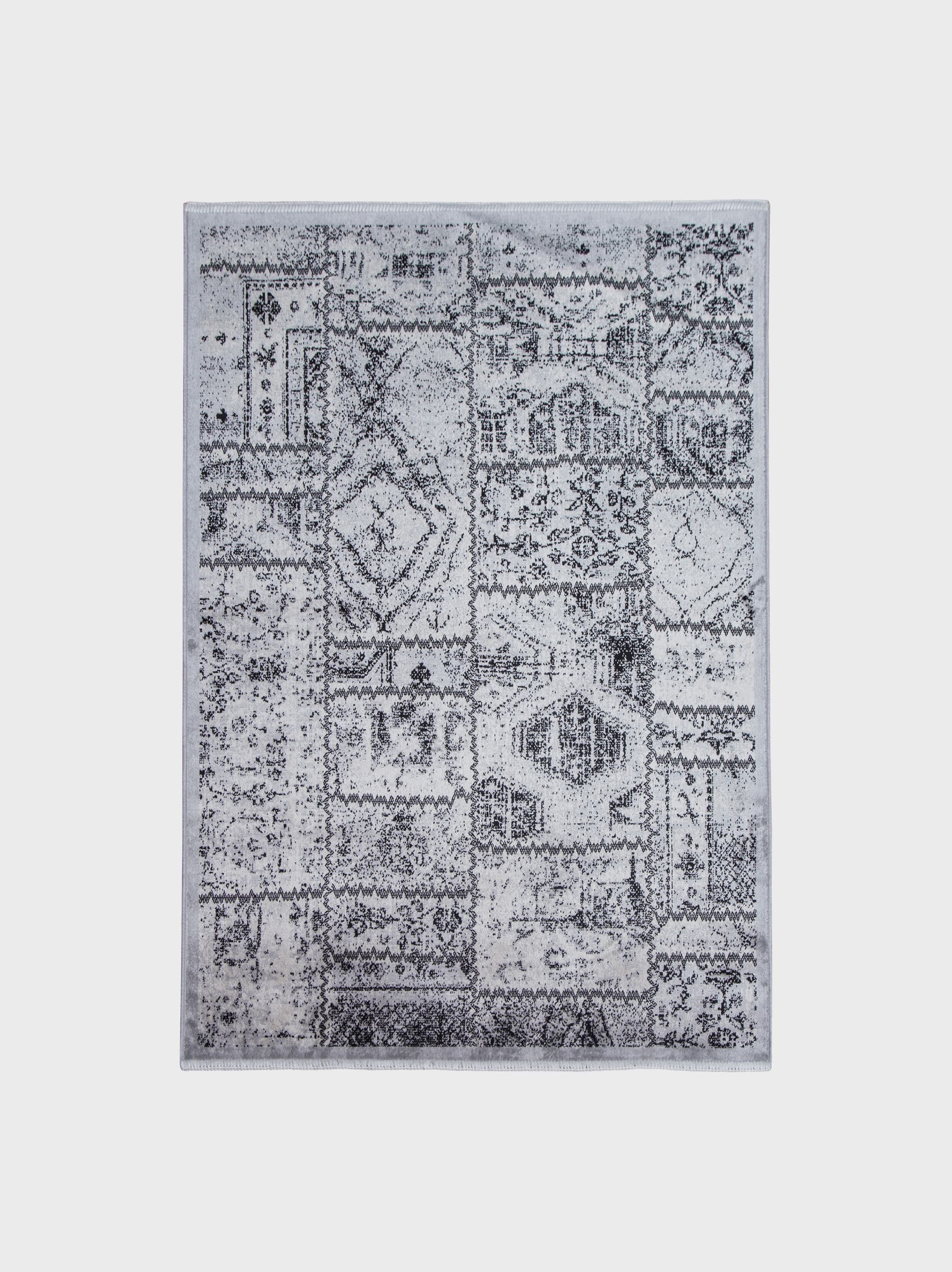 Patterned gray area rug after off-site wash